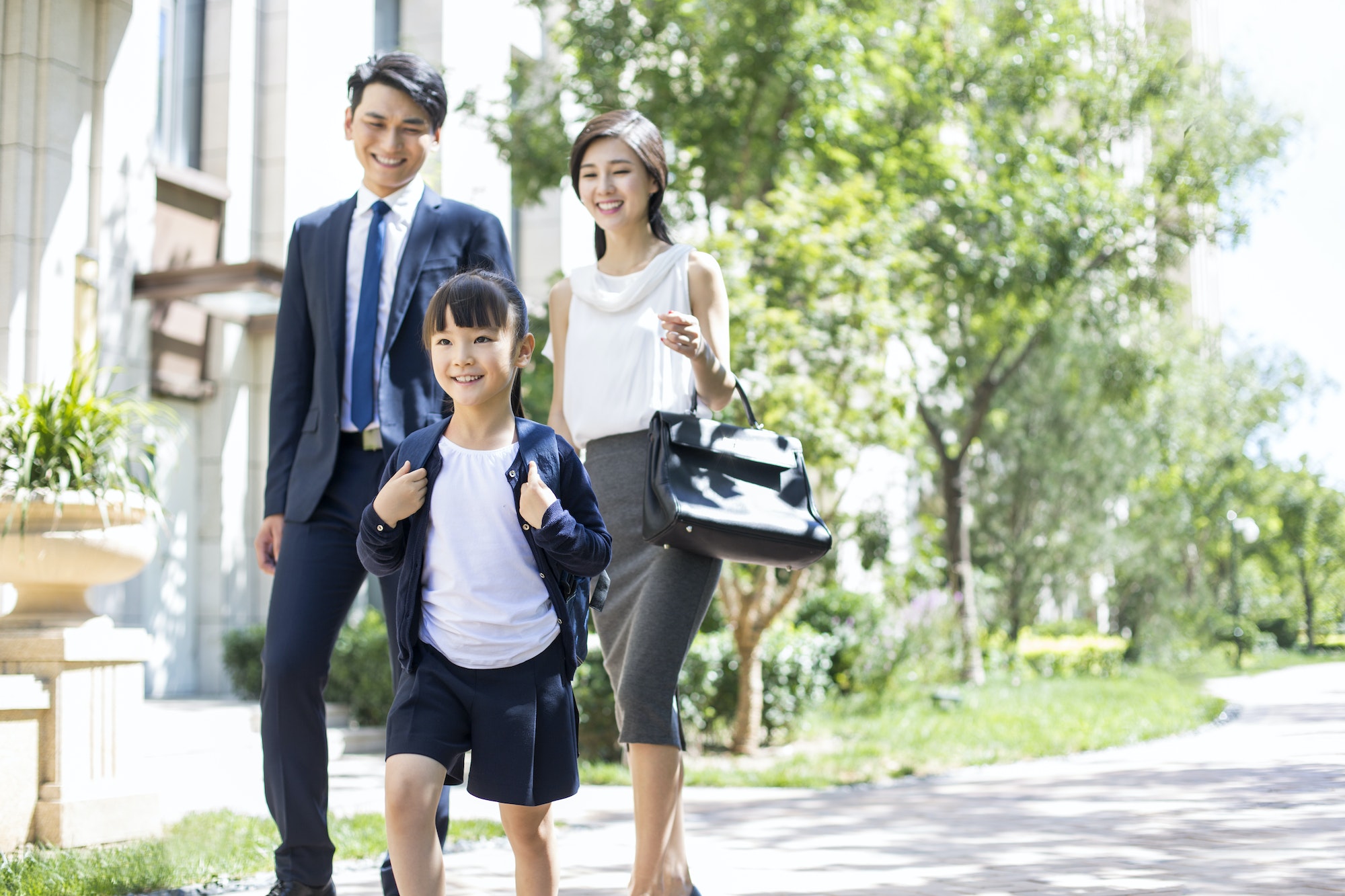 Parents taking their child to school in the morning